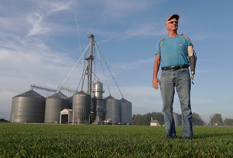 Jack Maloney poses Sept. 12, 2018, in front of the grain bins on his Little Ireland Farms in Brownsburg, Ind. Maloney, who farms about 2,000 acres in Hendricks County, said the aid for farmers is "a nice gesture" but what farmers really want is free trade, not government handouts. American farmers will soon begin getting checks from the government as part of a billion-dollar bailout to help those experiencing financial strain from President Donald Trump's trade disputes with China.