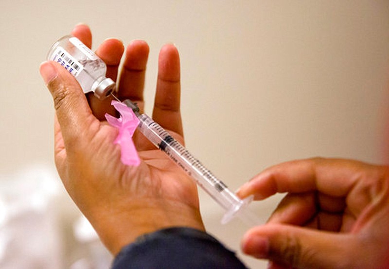 A nurse prepares a flu shot  on Feb. 7 at the Salvation Army in Atlanta. According to the CDC, flu costs the nation about $7 billion a year in sick days and lost productivity among working-age adults. That's not to mention the heavy toll of hospitalizations and deaths that occur mainly among people 65 and older. 

