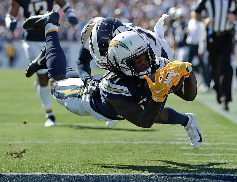  Los Angeles Chargers wide receiver Mike Williams scores in front of Los Angeles Rams defensive back Lamarcus Joyner during the second half of an NFL game Sunday in Los Angeles. 