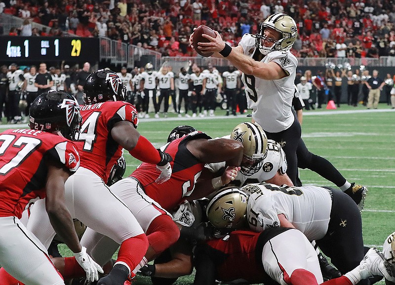  New Orleans Saints quarterback Drew Brees goes over the top for the winning touchdown in overtime to beat the Atlanta Falcons, 43-37, Sunday in Atlanta. 
