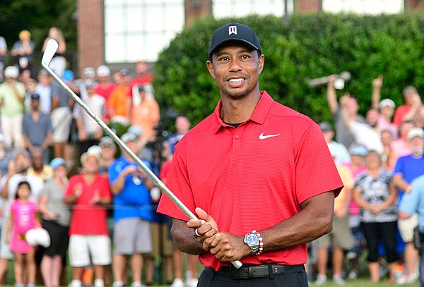 Tiger Woods holds Calamity Jane, the official trophy of the tournament, after winning the Tour Championship on Sunday in Atlanta.