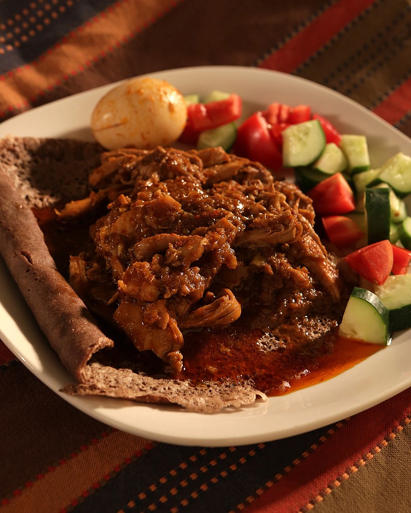 Doro wot (chicken) served with injera bread. (Hillary Levin/St. Louis Post-Dispatch/TNS) 