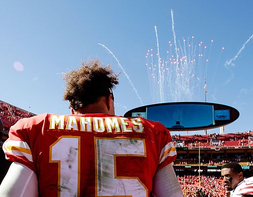 Chiefs quarterback Patrick Mahomes stands on the field as fireworks go off after Sunday afternoon's 38-27 victory against the 49ers at Arrowhead Stadium.