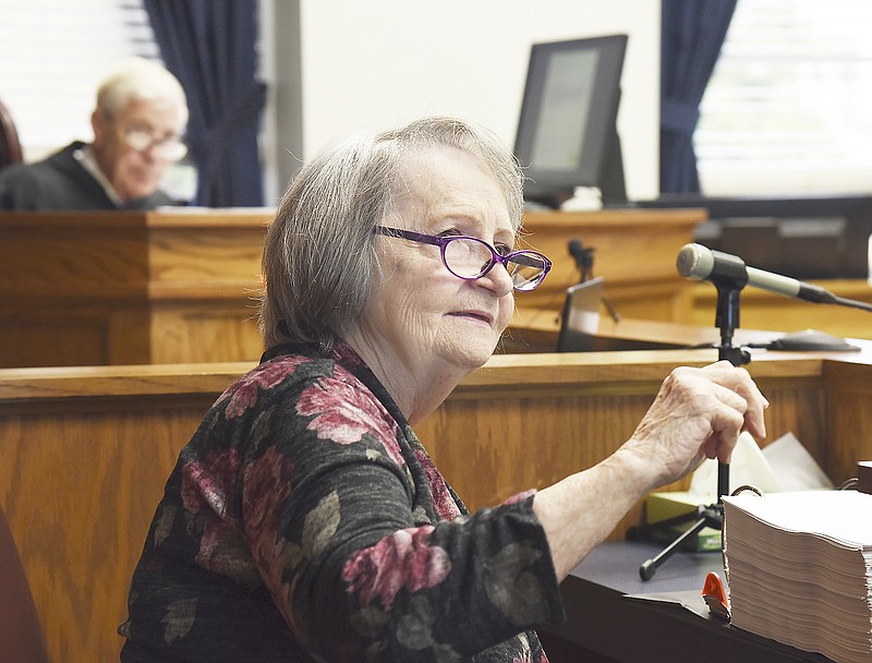 Mildred Gutierrez answers questions from attorneys representing their respective side in the case of Missouri's voter photo ID law being heard by Judge Richard Callahan, seen in background, Monday in a Cole County courtroom. 