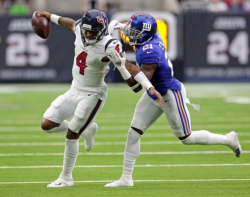 Huston Texans quarterback Deshaun Watson (4) is tackled by New York Giants defensive back Landon Collins (21) during the first half Sunday in Huston.