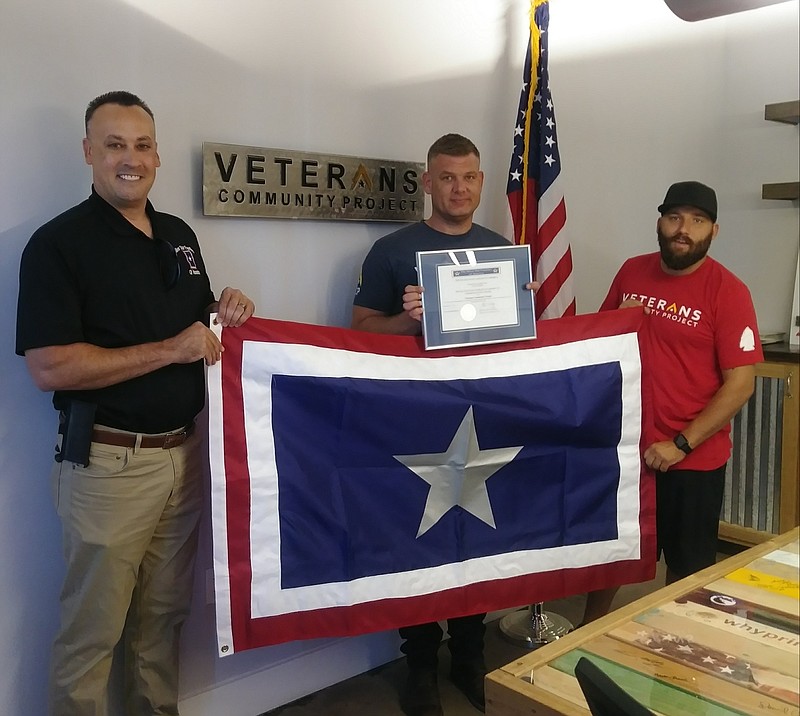 <p>Brandon Mixon, right, and Brian Meyer, center, both co-founders of Veterans Community Project, recently received the 2018 Silver Star Families of America (SSFOA) Commendation during a ceremony at their offices in Kansas City, Missouri. Courtesy of Tina Amick</p>