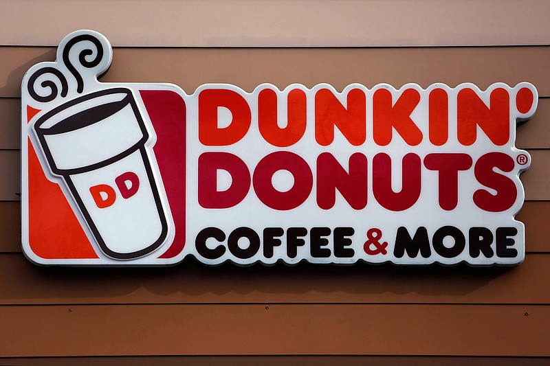 In this Jan. 22, 2018, file photo shows the Dunkin' Donuts logo on a shop in Mount Lebanon, Pa. Dunkin' is dropping the donuts — from its name, anyway. Doughnuts are still on the menu, but the company is renaming itself "Dunkin'" to reflect its increasing emphasis on coffee and other drinks. (AP Photo/Gene J. Puskar, File)