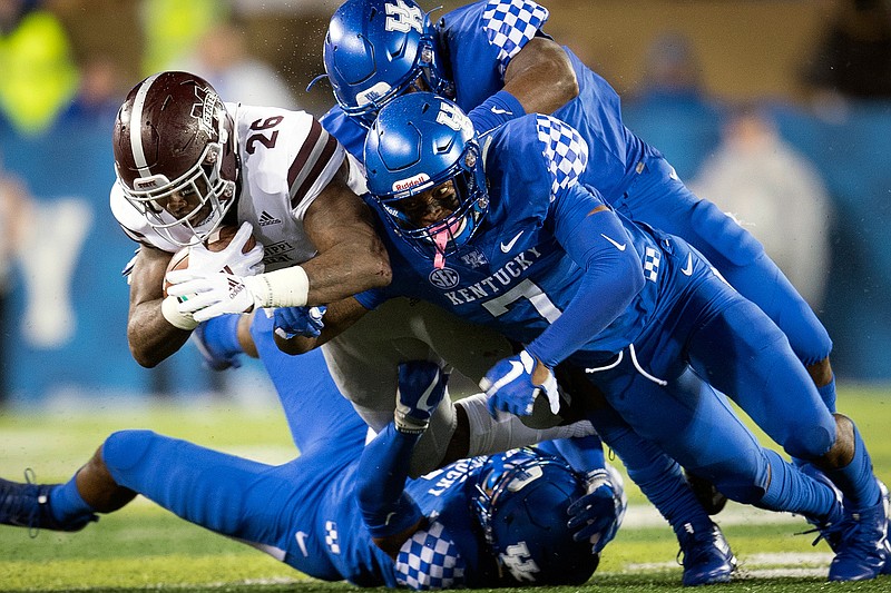 Mississippi State running back Aeris Williams (26) is tackled by several Kentucky defenders during the second half of an NCAA college football game in Lexington, Ky., Saturday, Sept. 22, 2018. (AP Photo/Bryan Woolston)