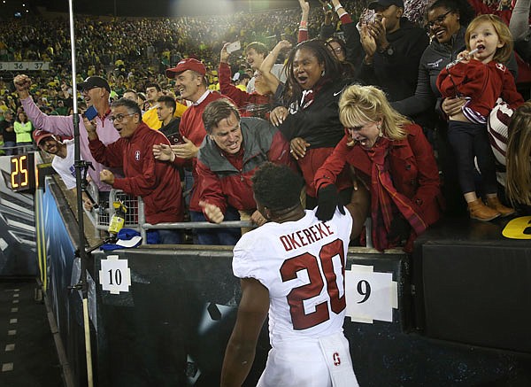 Stanford fans celebrate with Bobby Okereke at Autzen Stadium after Stanford's 38-31 overtime victory against Oregon on Saturday in Eugene, Ore.