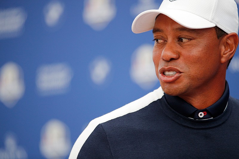 Tiger Woods of the U.S. leave the stage after answering questions during a press conference as part of the 2018 Ryder Cup at Le Golf National in Saint-Quentin-en-Yvelines, outside Paris, France, Tuesday, Sept. 25, 2018. The 42nd Ryder Cup will be held in France from Sept. 28-30, 2018 at Le Golf National. (AP Photo/Francois Mori)