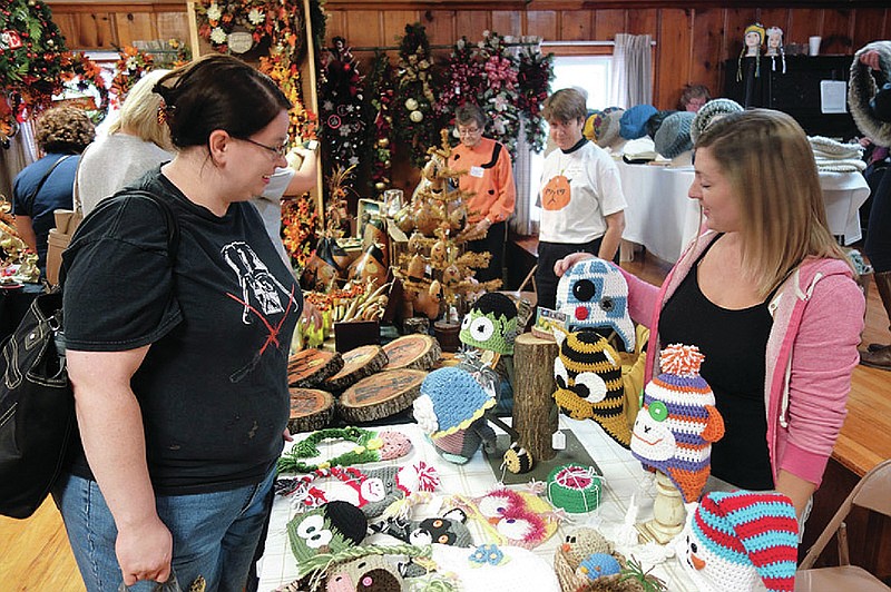 <p>Allie Talley (left) asks Ashley Leakey about her custom crocheted hat made to look like the droid ‘R2D2’ from ‘Star Wars’ at the craft show in Hatton several years ago. (Fulton Sun file photo)</p>