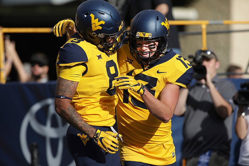West Virginia wide receiver David Sills V (13) celebrates with wide receiver Marcus Simms (8) after Simms scored a touchdown during the first half of an NCAA college football game Saturday, Sept.22, 2018, in Morgantown, W.Va. (AP Photo/Raymond Thompson)