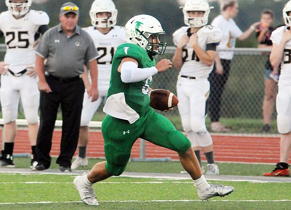 Blair Oaks quarterback Nolan Hair rushes for a gain during a game earlier this month against Versailles at the Falcon Athletic Complex in Wardsville.
