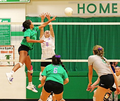 Mariah Radmacher of Blair Oaks spikes the ball past Anna Markway of Fatima during Thursday's match in Wardsville.