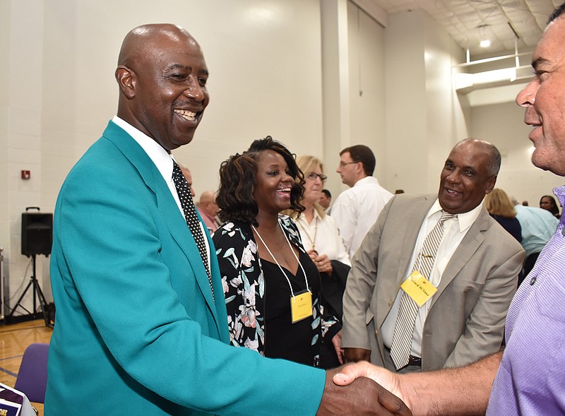 Former Miami Dolphins and Ashdown High School Panther football player Earnest Rhone, center, visits with family and friends during the recent Ashdown Alumni Association banquet. Rhone, a graduate of Henderson State University,  was honored as an outstanding Ashdown graduate.