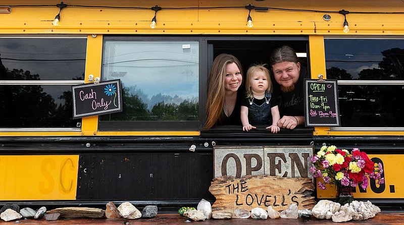 Stacee, left, Journee and Lance Lovell pose in the serving window of their taco bus on U.S. Highway 59 in Liberty-Eylau. Open since August, the business has found success in serving chicken street tacos, a taco on a bun and cheesy smoked turkey sandwiches.