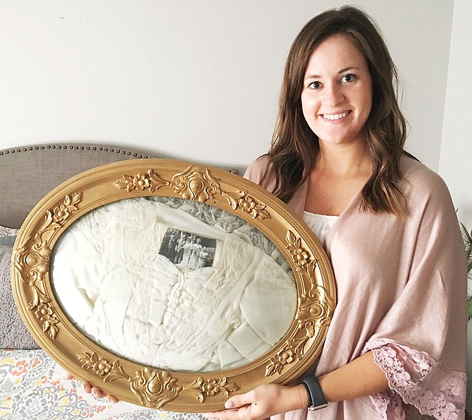 Ashley Roling shows the frame that holds her grandmother's wedding dress, which normally hangs above the bed. Roling and her single mom moved into her grandmother's house when she was young so her grandmother could take care of her. When her grandmother's Alzheimer's disease advanced, they moved in again, but this time to care for her.