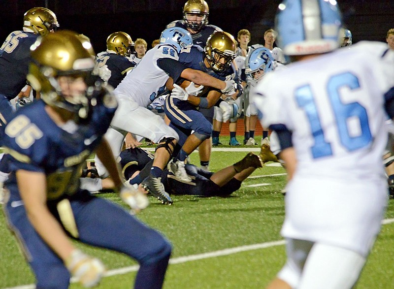 Helias running back Zach Covington battles for more yardage during Saturday night's Homecoming game against Father Tolton at the Crusader Athletic Complex.