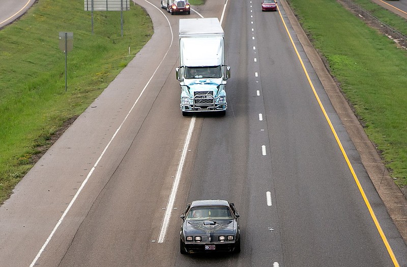 A black Pontiac Trans Am drives Sunday down Interstate 30 East toward Little Rock, followed by several 18-wheelers. The Small Business in Transportation Coalition, a trucking industry group, held a memorial tribute and procession for Burt Reynolds on Saturday and Sunday, Sept. 29-30, 2018, with bands, movies and a duplication of the drive from Texarkana to Atlanta, Ga. The actor, who died Sept. 6, was well-known for his role as "Bandit" in the "Smokey and the Bandit" movie trilogy.