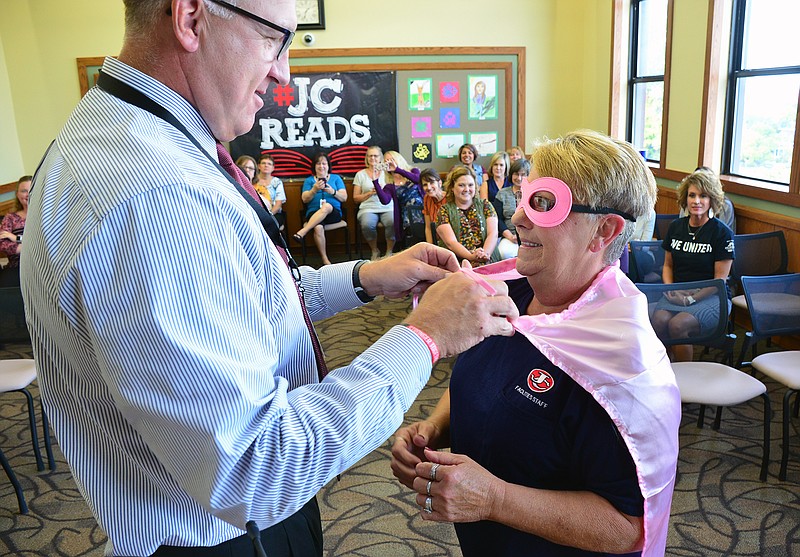 National Custodial Worker Day
Mark Wilson/News Tribune
Connie Klund is reconized on National Custodial Worker Recognition Day by Jefferson City Public Schools Superintendent Larry Linthacum as he drapes her in a superhero cape and mask Tuesday as staff looks on. It was a super thank you to the men and women who work tirelessly to clean and maintain the many buildings that comprise JCPS.