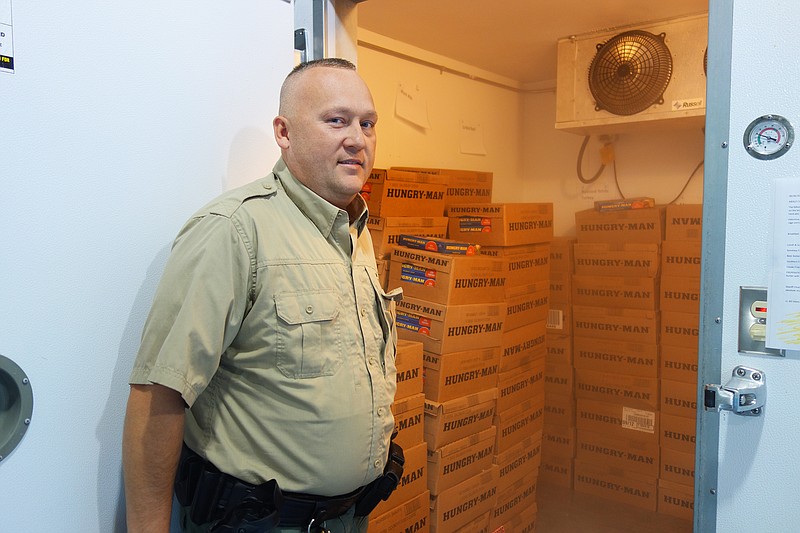 <p>Helen Wilbers/For the News Tribune</p><p>Callaway County Jail Administrator Robert Harrison opens the freezer where inmates’ meals are stored. After the abrupt closure of the jail’s former supplier, Mosers began supplying meals in July 2018.</p>