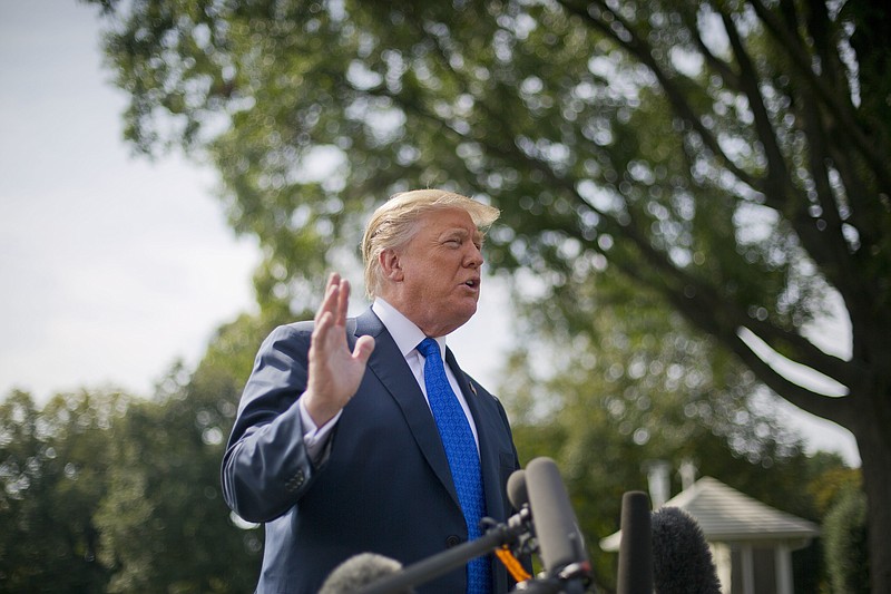President Donald Trump gestures while answering questions from members of the media before walking across the South Lawn of the White House in Washington, Tuesday, Oct. 2, 2018, to board Marine One helicopter for a short trip to Andrews Air Force Base, Md., en route to Philadelphia. (AP Photo/Pablo Martinez Monsivais)