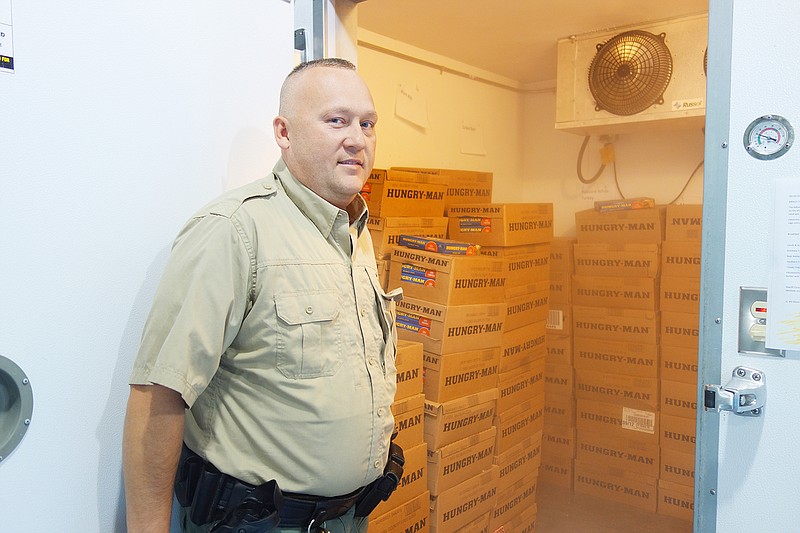 Callaway County Jail Administrator Robert Harrison opens the freezer where inmates' meals are stored. After the abrupt closure of the jail's former supplier, Mosers began supplying meals in July.