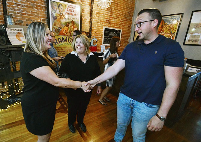 Michele Sloan, owner of 1st Choice Real Estate School and Michele Sloan LLC, talks with Sarah Fontaine, left, of the Jefferson City Area Board of Realtors, and Mitchell Woodrum, who is with the Jefferson City Human Relations Commission, prior to a presentation on diversity and fair housing Tuesday at Capitol City Cinema. Sloan is an instructor with the "At Home with Diversity" program.