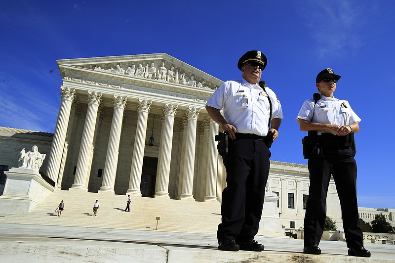 U.S. Supreme Court Police Department officers stand in front of the Supreme Court in Washington, Thursday, Oct. 4, 2018. (AP Photo/Manuel Balce Ceneta)
