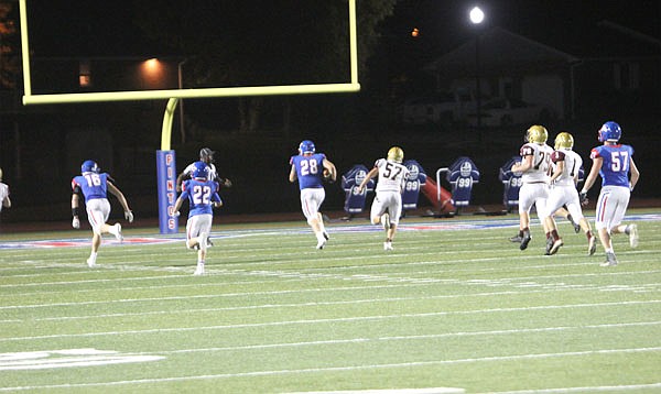 California's Trystan Hees (28) races past the Eldon defense for a 79-yard touchdown reception during last Friday night's Homecoming game in California.