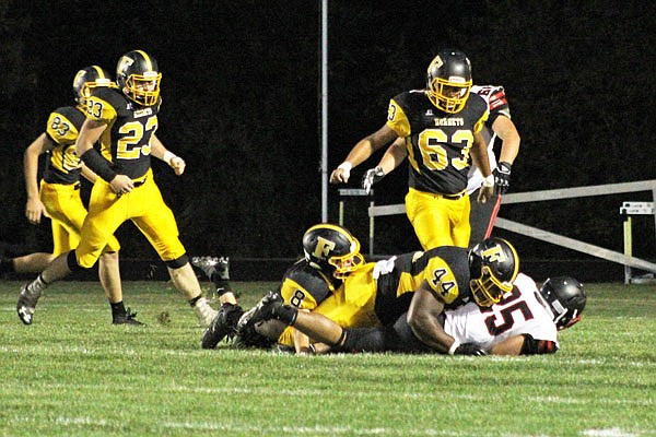 Fulton senior linebacker Latrellus Colbert (44) takes down a Hannibal ball carrier during the Hornets' 47-0 loss in North Central Missouri Conference play to the Pirates last Friday at Robert E. Fisher Jr. Stadium in Fulton.