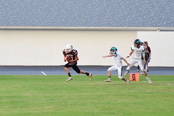 Kodie Dick of the Tipton Cardinals takes off with the football during a game this season against North Callaway.