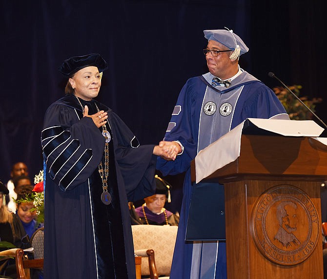 Marvin Teer, Jr. right, formally introduces Jerald Jones Woolfolk on Friday as Lincoln University's 20th president near the end of a two-hour ceremony in Mitchell Auditorium in Richardson Fine Arts Center. 