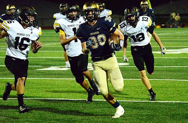 Blake Veltrop runs past three defenders during Friday night's game against Monroe City at Ray Hentges Stadium.