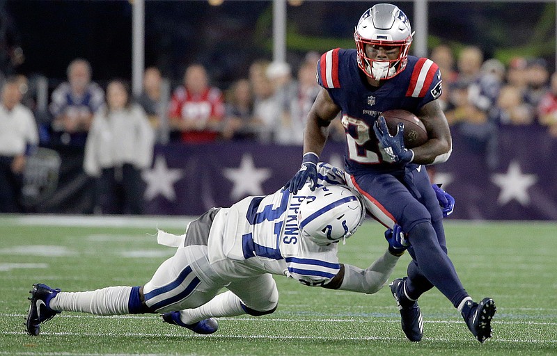 New England Patriots running back James White (28) eludes Indianapolis Colts cornerback Lenzy Pipkins (37) during the second half of an NFL football game, Thursday, Oct. 4, 2018, in Foxborough, Mass. (AP Photo/Steven Senne)