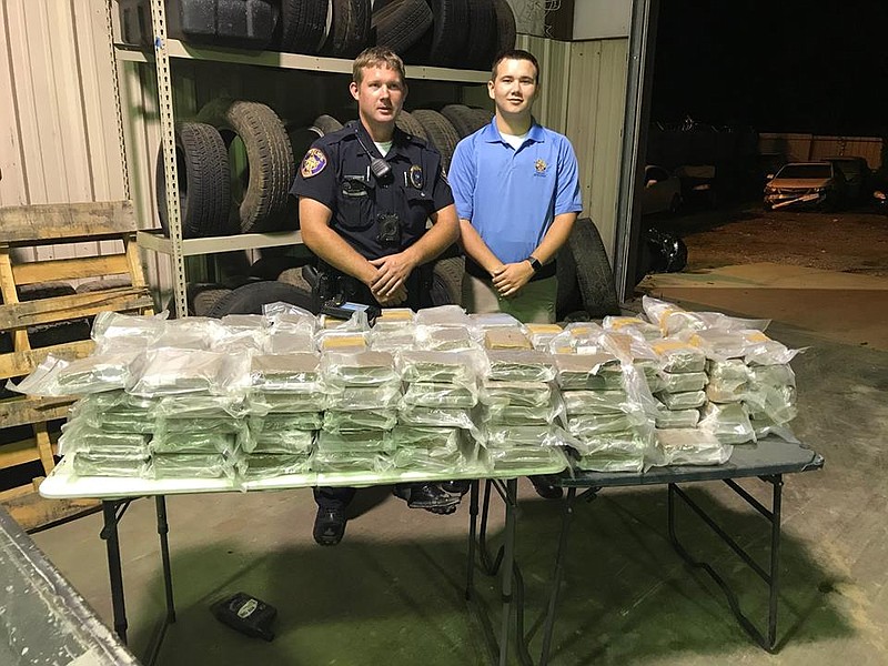 Police stand with drugs confiscated during a traffic stop. (Submitted photo)
