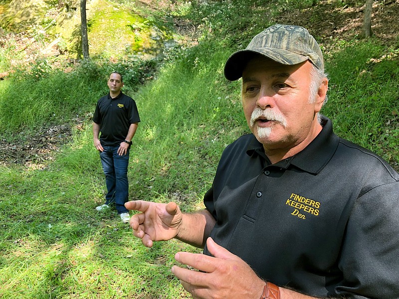 In this Sept. 20, 2018 photo, Dennis Parada, right, and his son Kem Parada stand at the site of the FBI’s dig for Civil War-era gold in Dents Run, Pennsylvania. The FBI says the excavation came up empty, but the Paradas believe investigators might have found the legendary gold cache. (AP Photo/Michael Rubinkam)