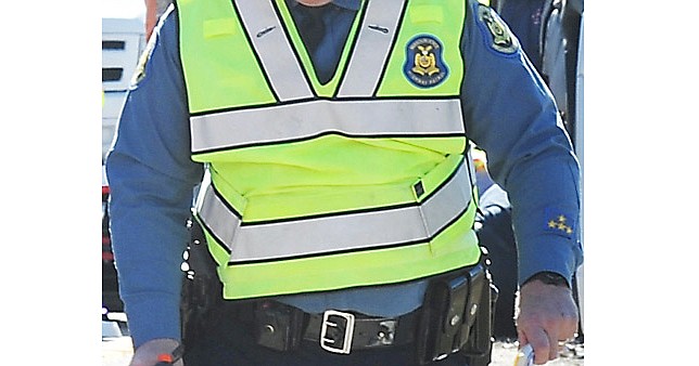 A Missouri State Highway Patrol trooper takes measurements while investigating an accident scene. (Archive photo)