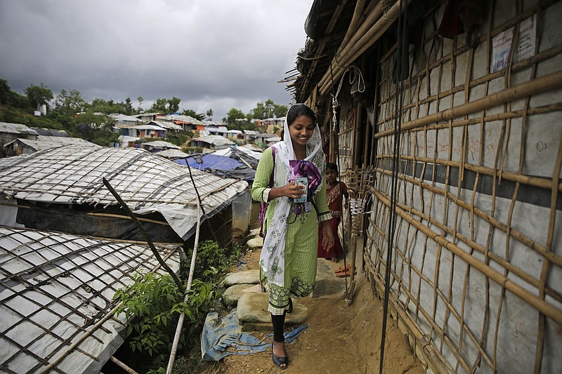 In this Aug. 27, 2018, photo, Rahima Akter walks through Balukhali refugee camp in Bangladesh. Rahima is a 19-year-old refugee who dreams of becoming the most educated Rohingya woman in the world. She recently finished high school and hopes to study human rights in college. (AP Photo/Altaf Qadri)