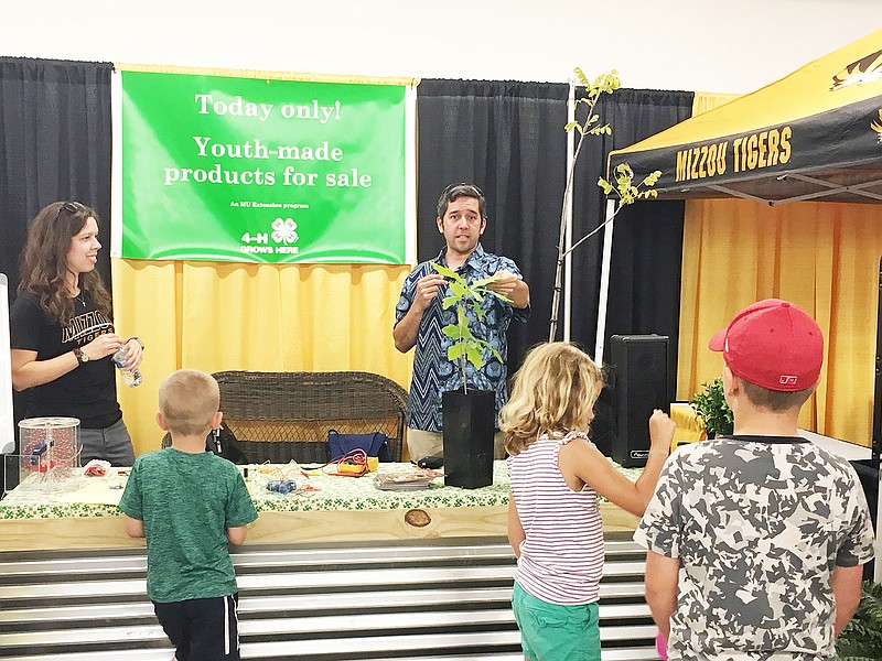 Anna Pittman, left, a member of the Science on Wheels coordinating committee, and Science on Wheels presenter Michael Borucke educate children about plants at a recent event. Science on Wheels is coming to Serenity Valley Winery this Saturday.