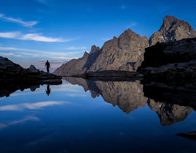 Mount Owen and the Grand Teton are reflected in a small alpine lake, which empties into Jenny Lake.  (Photo for The Washington Post by Dina Mishev)