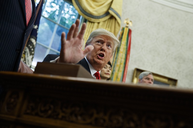 President Donald Trump talks with reporters during a signing ceremony for the "Save Our Seas Act of 2018" in the Oval Office of the White House, Thursday, Oct. 11, 2018, in Washington. (AP Photo/Evan Vucci)