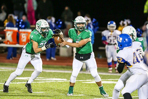 Blair Oaks quarterback Nolan Hair (right) hands the ball off to Braydan Pritchett during last year's district semifinal game against Wright City at the Falcon Athletic Complex in Wardsville. Hair and Pritchett will be among the 12 Blair Oaks seniors honored prior to tonight's Senior Night game against School of the Osage.