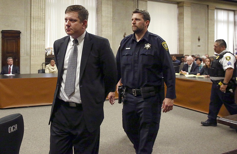 Chicago police Officer Jason Van Dyke, left, is taken into custody after jurors found him guilty of second-degree murder and aggravated battery in the 2014 shooting of black teenager Laquan McDonald on Friday, Oct. 5, 2018, at the Leighton Criminal Court Building in Chicago.