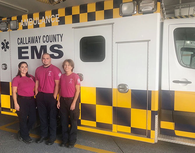 Paramedic shift supervisor Susan Hertzler (left), EMT Matt D'Angelo, and paramedic training officer Kelly Drennan show off their Breast Cancer Awareness shirts. They work at the Callaway County Ambulance District. 