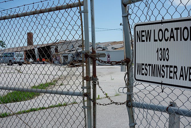 Workers survey damage Tuesday from the old city warehouse on Westminster Avenue. City departments moved into new quarters last year farther north.