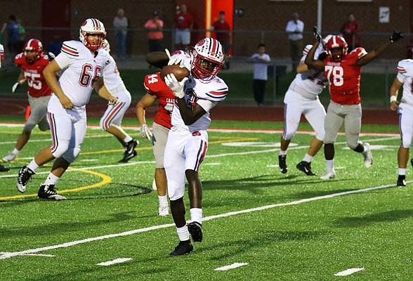 Jays receiver Christian White looks to run after catching a pass during a game earlier this season against Chaminade in St. Louis.