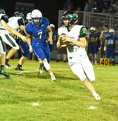 North Callaway junior quarterback Jadon Henry rolls away from pressure while looking to throw a pass during the Thunderbirds' 40-34 Eastern Missouri Conference loss at Montgomery County last week. North Callaway will try to rebound tonight at home against Mark Twain.