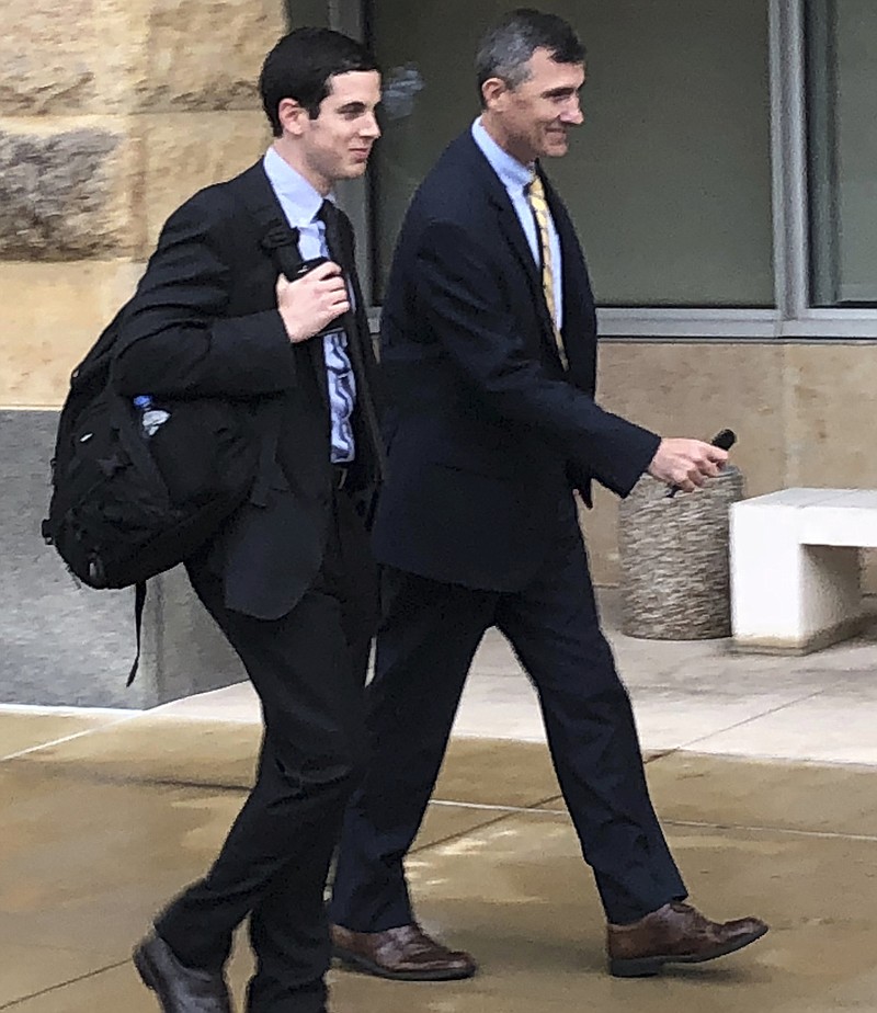 CORRECTS IDENTITY OF DENNIS BOYLE, LEFT, AND BLERINA JASARI, TO U.S. ATTORNEY GREGORY BERNSTEIN, LEFT,  AND FBI SPECIAL AGENT KEITH CUSTER - U.S. Attorney Gregory Bernstein, left, and FBI Special Agent Keith Custer walk outside the federal courthouse, Thursday, Oct. 11, 2018, in Greenbelt, Md. Authorities and a government witness say that investment adviser Dawn Bennett, cast paranormal spells and spent nearly three-quarters of a million dollars on prayers in a desperate attempt to avoid charges that she orchestrated a multimillion-dollar Ponzi scheme. Bernstein is one of the prosecutors in the case against Bennett and Custer was one of the agents who investigated the case. (AP Photo/Michael Kunzelman)