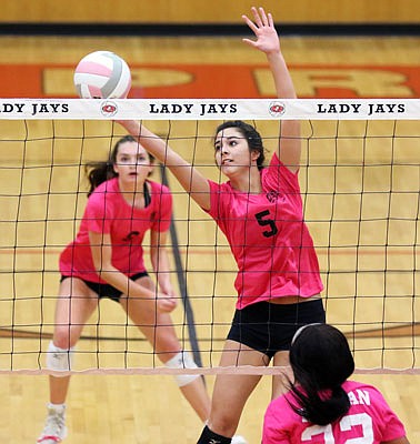 Ella Wang of the Lady Jays tries to keep the ball alive during Thursday's match against Hickman at Fleming Fieldhouse.